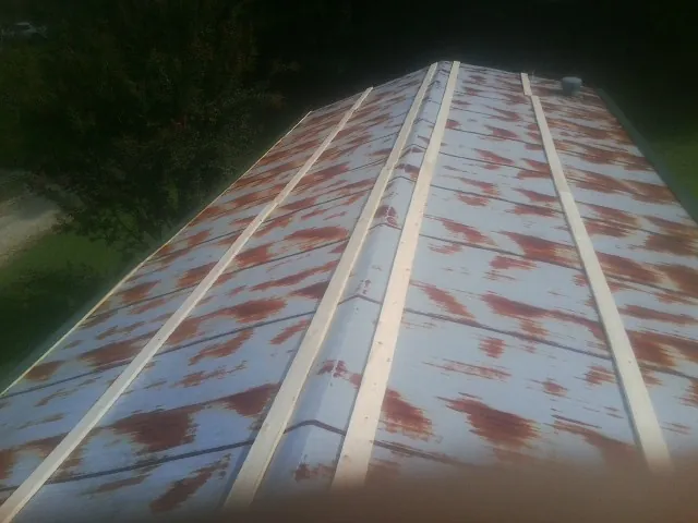 Rusted metal roof panels with new wood purlins before replacement — Storm Damage Roof Repair in Schertz by Roofing Brothers
